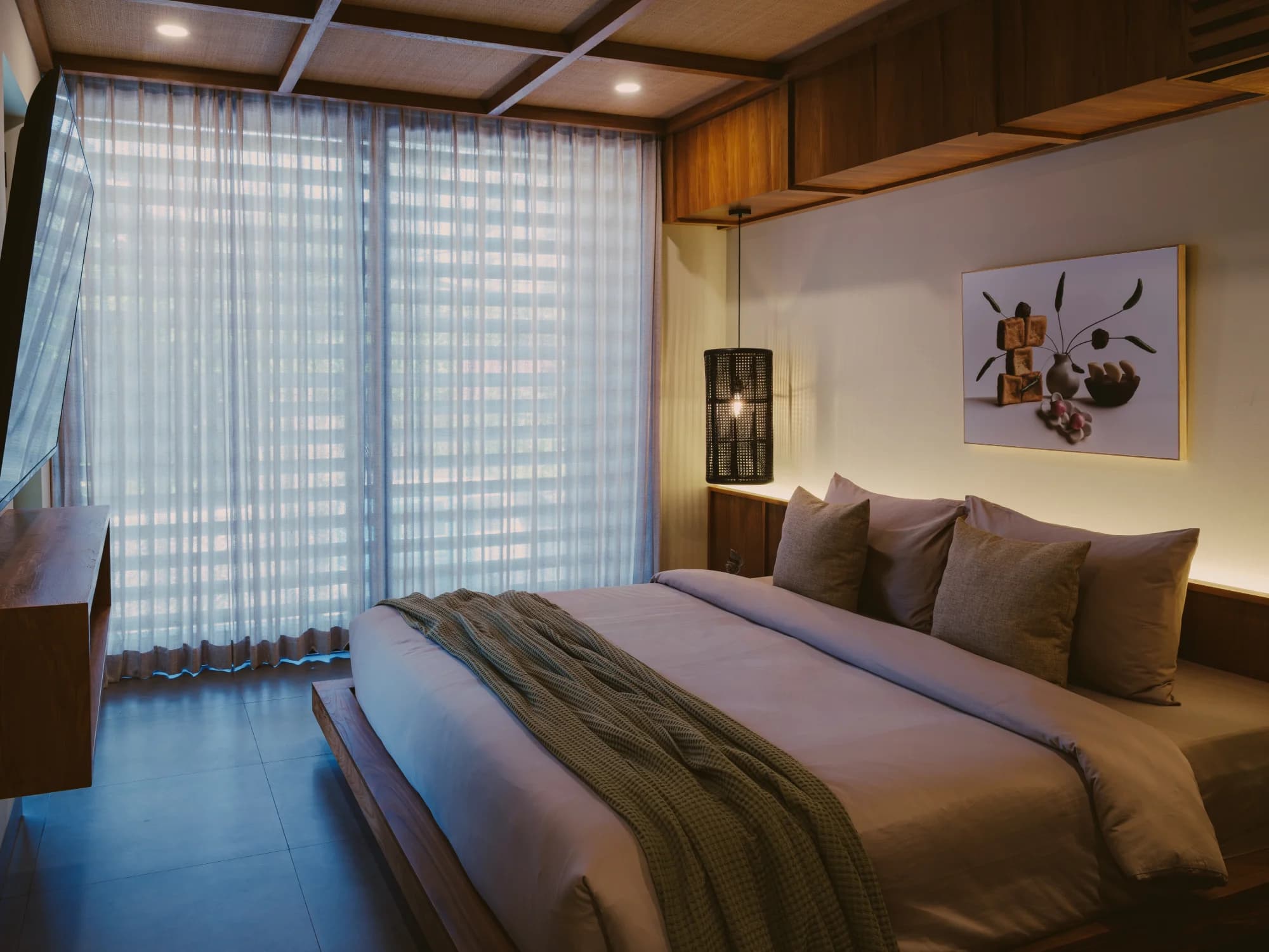 Studio Apartment interior with comfortable king bed and warm lighting