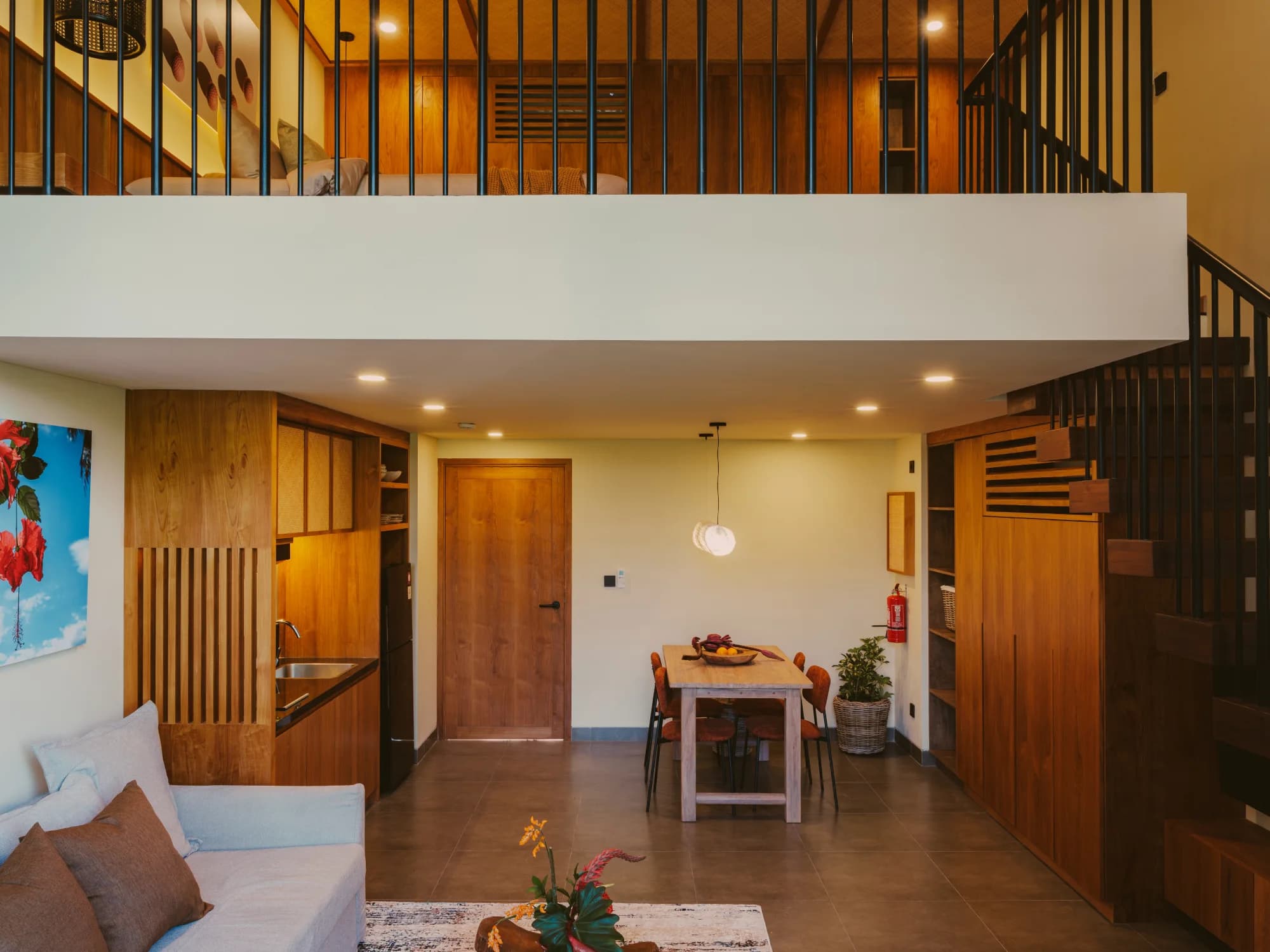 Deluxe mezzanine duplex suite with double-height ceiling and comfortable lounge