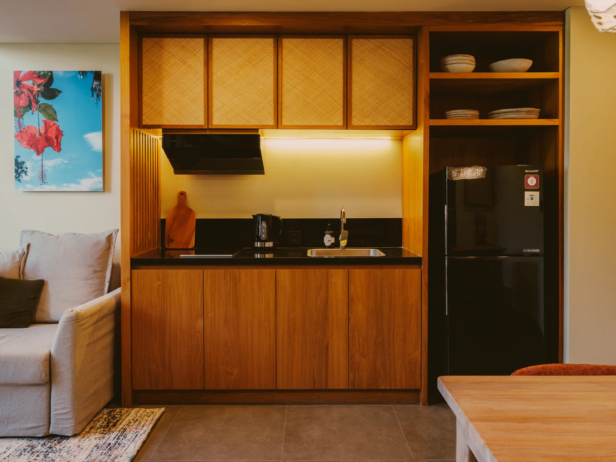 Fully-equipped apartment kitchen with induction stove and teak finishes