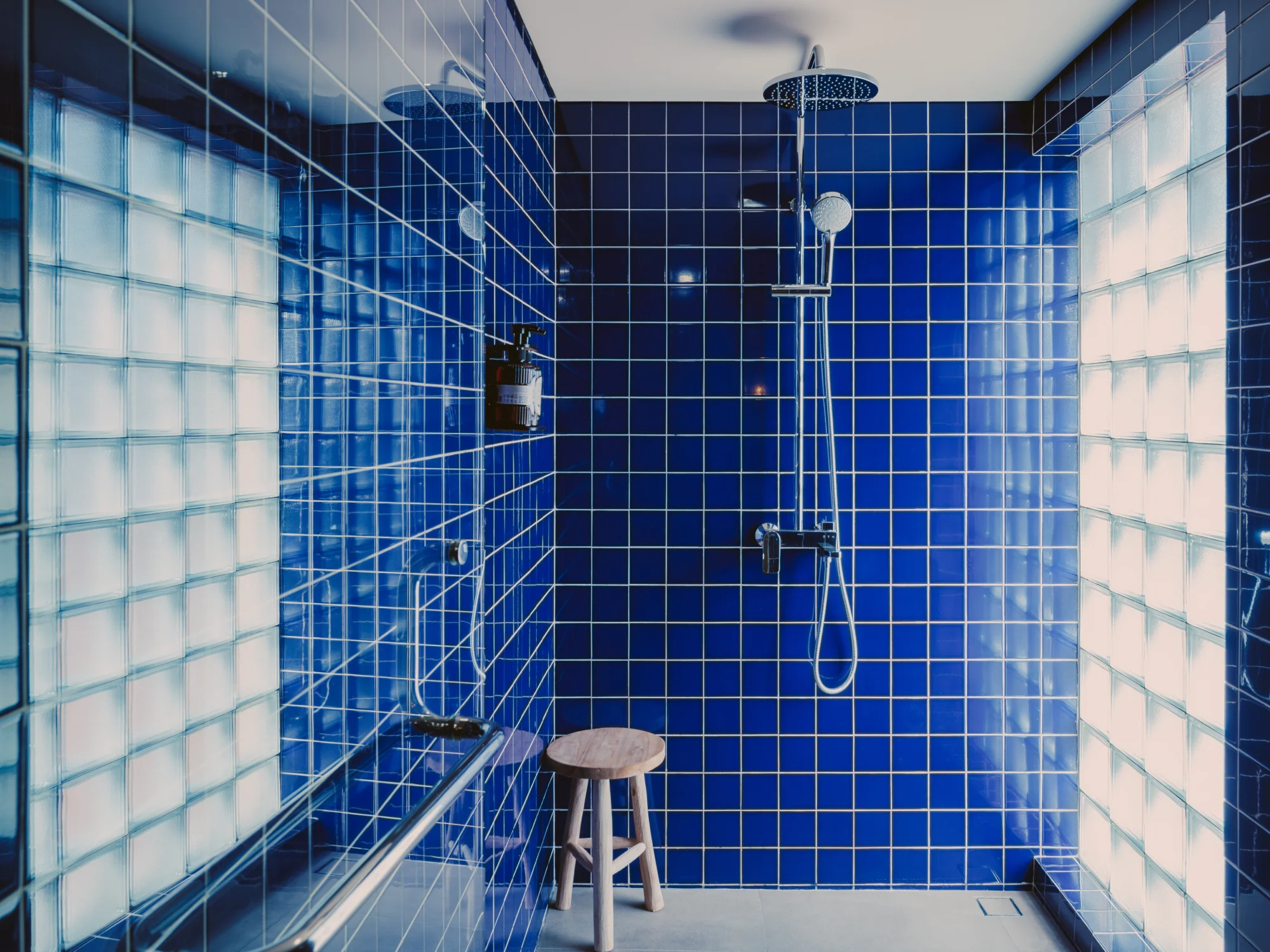 Modern private bathroom with glass walk-in shower and stone vanity