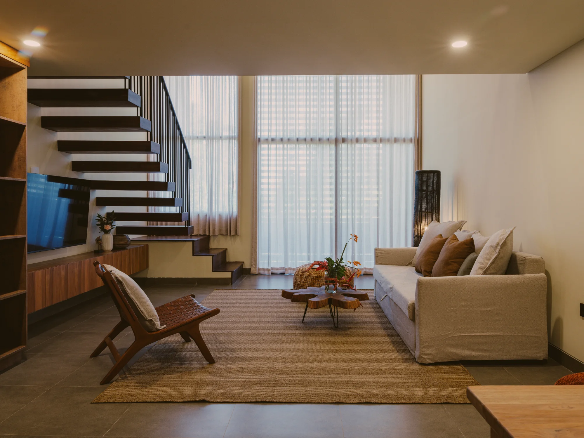 Double-height mezzanine ceiling and expansive sofa lounge