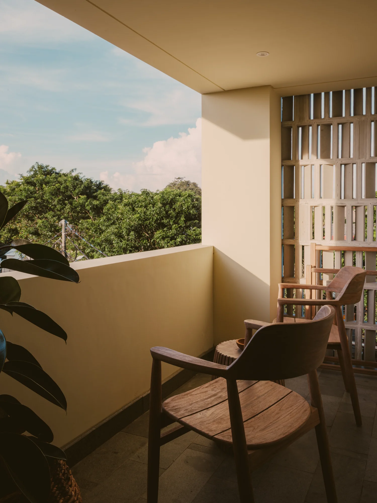 Sunlit balcony framing tropical greenery and fresh island air